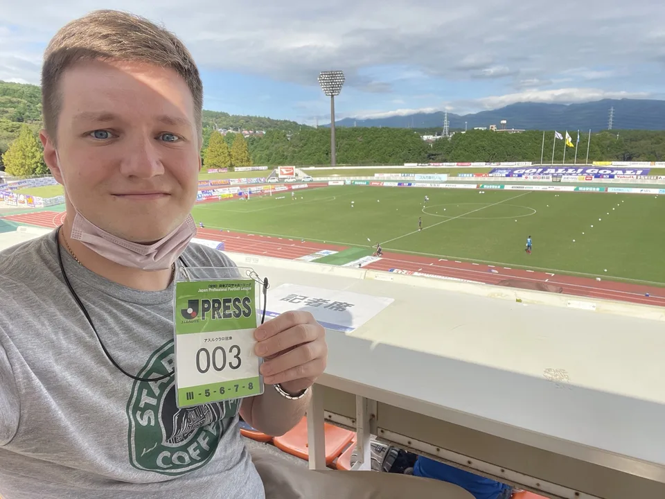 Dmitry with press accreditation at a Japanese football stadium